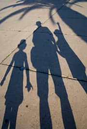 shadows of parent and two kids