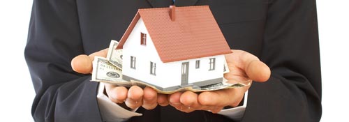 man holding house and money