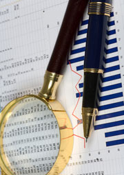Financials magnifying glass and pen