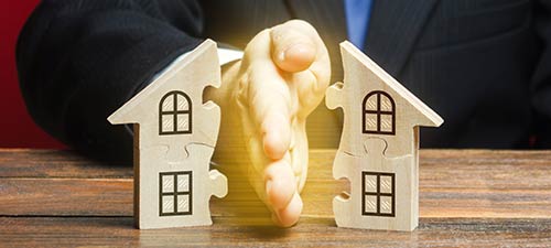 hand dividing house in half