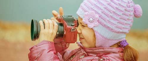 toddler with camera