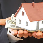 hands holding house and money